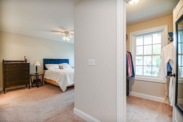 bedroom featuring carpet flooring, baseboards, multiple windows, and ceiling fan