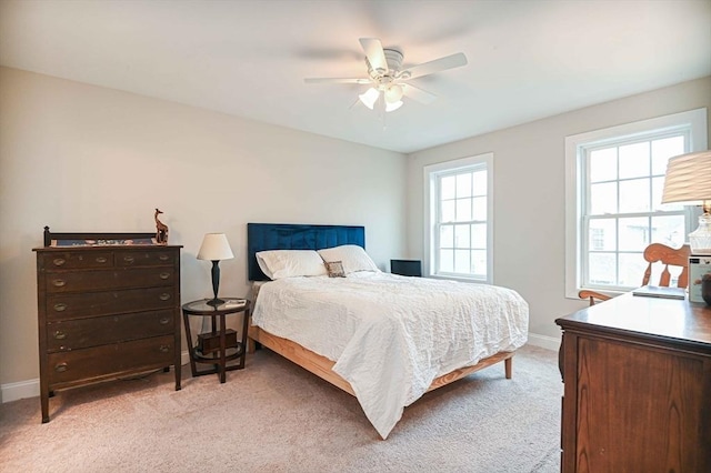 bedroom with baseboards, light colored carpet, and ceiling fan