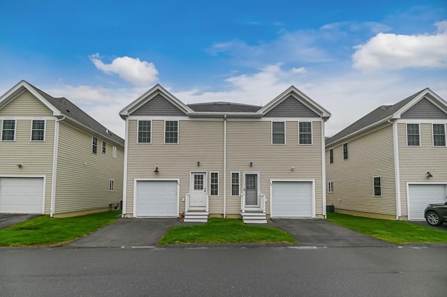 view of front of house with asphalt driveway, entry steps, and an attached garage