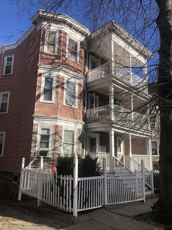 exterior space with a porch and a balcony