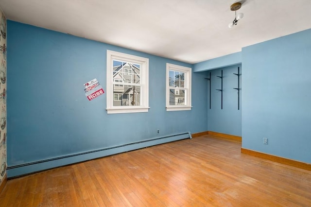 empty room featuring light hardwood / wood-style flooring and baseboard heating