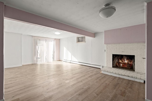 unfurnished living room with a fireplace, a baseboard radiator, and light hardwood / wood-style floors