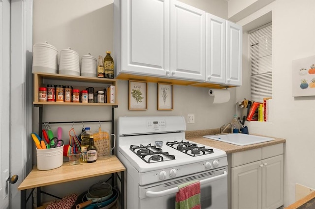293-295 Commonwealth Ave Unit 3B, Boston, MA 02115 - kitchen with white gas stove, a sink, white cabinets, and light countertops