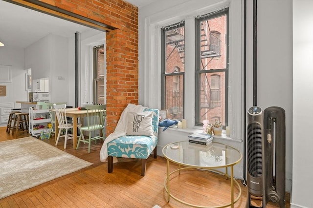 293-295 Commonwealth Ave Unit 3B, Boston, MA 02115 - living area with hardwood / wood-style flooring and brick wall