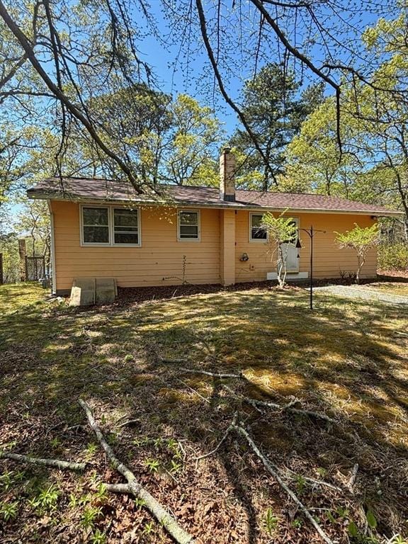 83 Partridge Valley Rd, Yarmouth, MA 02673 - rear view of house featuring a chimney and a lawn