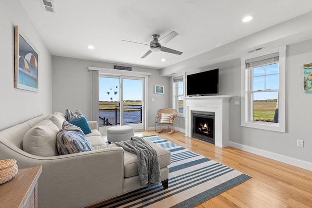 35 Liberty St, Salisbury, MA 01952 - living room featuring a ceiling fan, a lit fireplace, wood finished floors, recessed lighting, and baseboards
