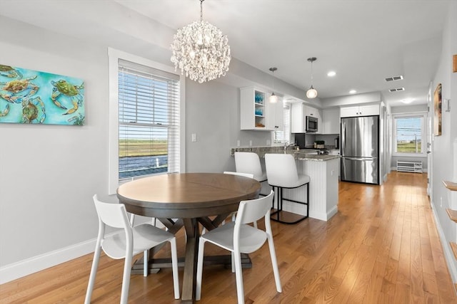 35 Liberty St, Salisbury, MA 01952 - dining area with a chandelier, light wood finished floors, baseboards, and recessed lighting