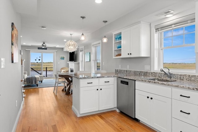 35 Liberty St, Salisbury, MA 01952 - kitchen featuring stainless steel dishwasher, a sink, a peninsula, open floor plan, and white cabinets