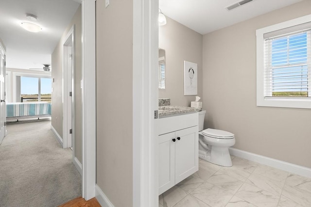 35 Liberty St, Salisbury, MA 01952 - bathroom with vanity, toilet, baseboards, and marble look tile flooring