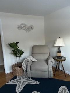 sitting room featuring baseboards and wood finished floors