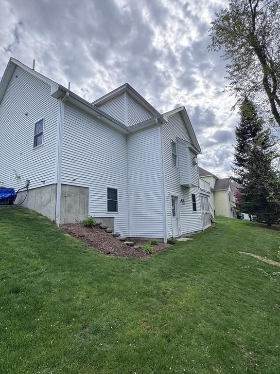 view of side of home with a lawn