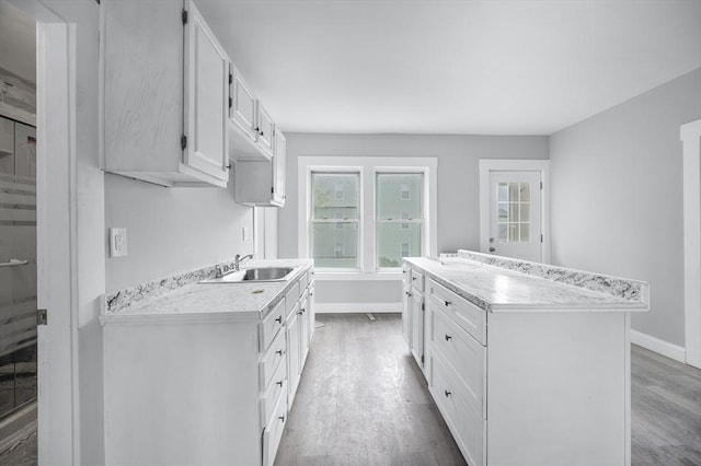 14-18 Florence St, Leominster, MA 01453 - kitchen featuring a sink, baseboards, wood finished floors, and light countertops
