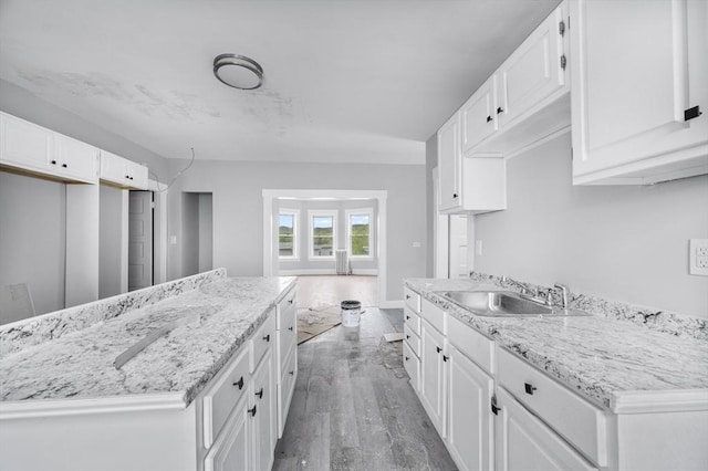14-18 Florence St, Leominster, MA 01453 - kitchen featuring a sink, white cabinets, light wood-style floors, and light stone counters