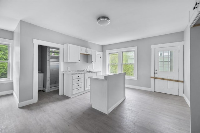 14-18 Florence St, Leominster, MA 01453 - kitchen featuring baseboards, light countertops, plenty of natural light, and white cabinetry
