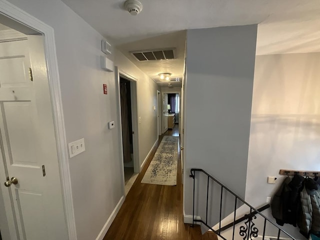 hall with dark wood-type flooring