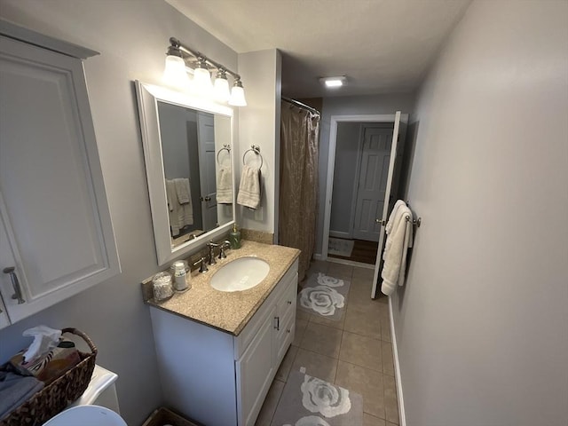 bathroom with tile patterned floors, vanity, and walk in shower