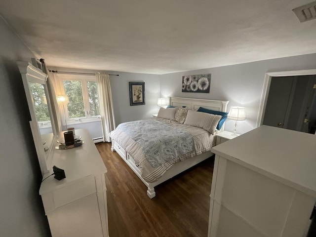 bedroom featuring dark wood-type flooring and a baseboard radiator