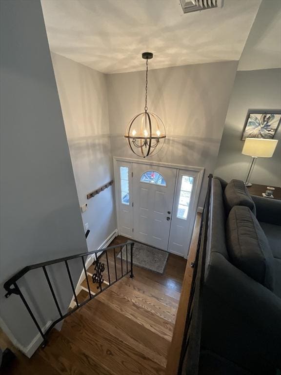 foyer entrance with a chandelier and hardwood / wood-style flooring