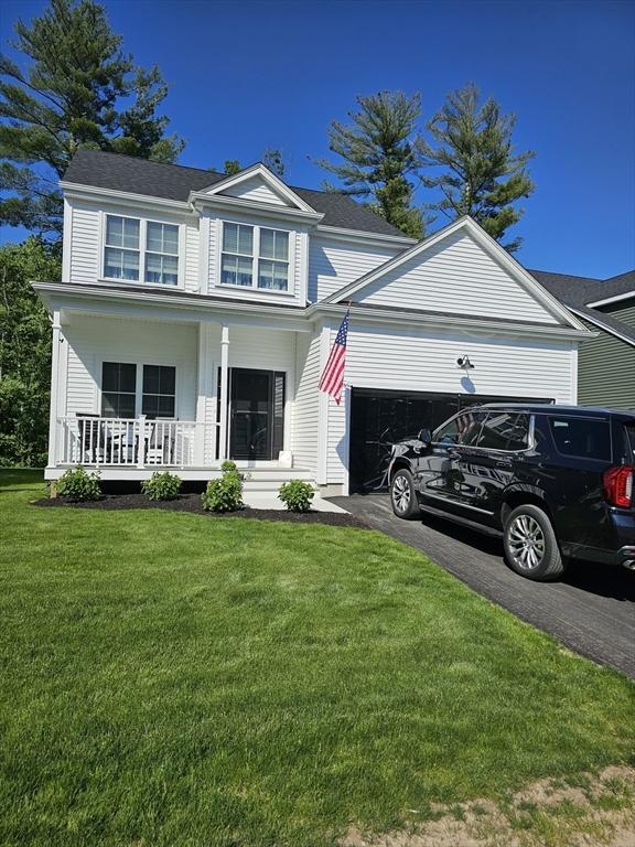 3 Panda Ct Unit 3, Milford, MA 01757 - view of front of house featuring an attached garage, covered porch, asphalt driveway, and a front yard
