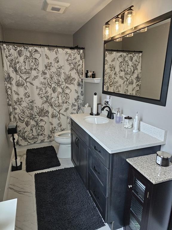3 Panda Ct Unit 3, Milford, MA 01757 - full bath with marble look tile flooring, vanity, and a shower with shower curtain