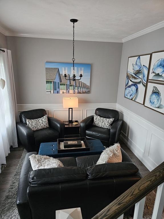 3 Panda Ct Unit 3, Milford, MA 01757 - living area with a chandelier, wood finished floors, ornamental molding, and a wainscoted wall