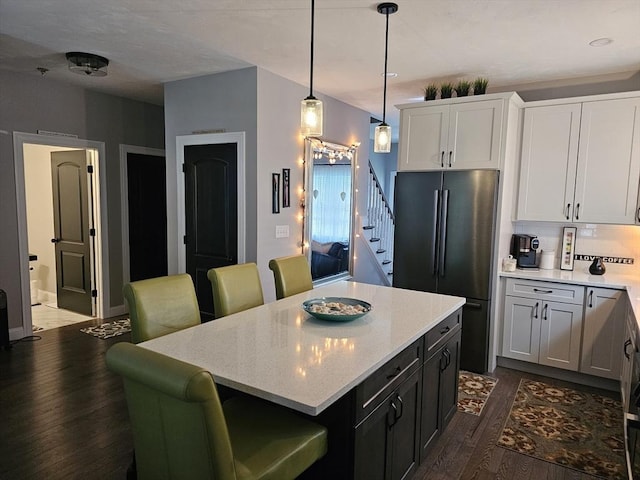 3 Panda Ct Unit 3, Milford, MA 01757 - kitchen featuring freestanding refrigerator, dark wood-style floors, a breakfast bar, white cabinets, and hanging light fixtures
