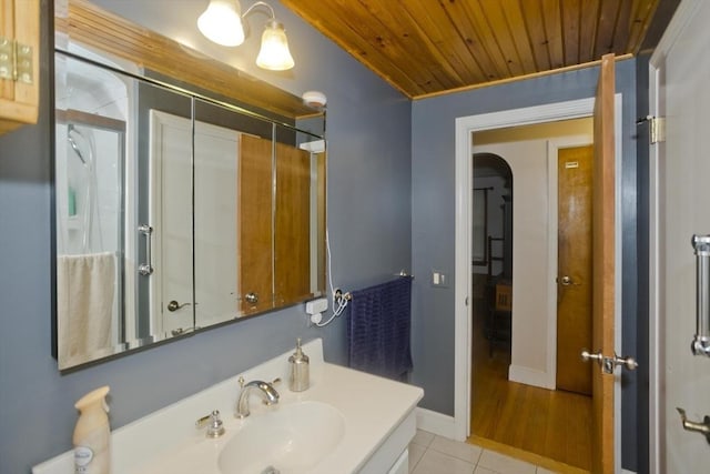 bathroom featuring tile patterned flooring, vanity, and wood ceiling