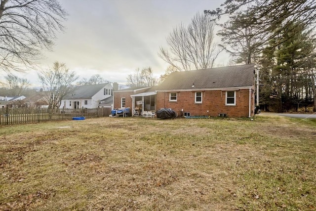 back of house featuring a lawn