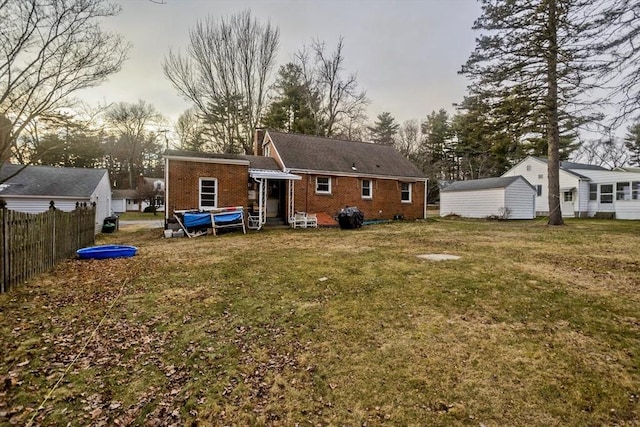 rear view of property featuring a yard