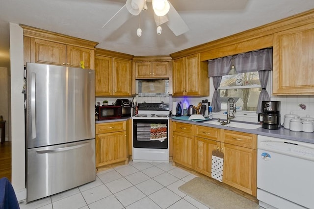 kitchen featuring ceiling fan, sink, tasteful backsplash, white appliances, and light tile patterned floors