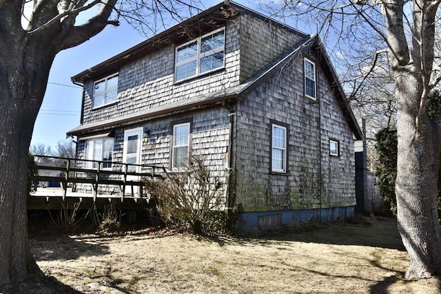 view of side of home featuring a wooden deck