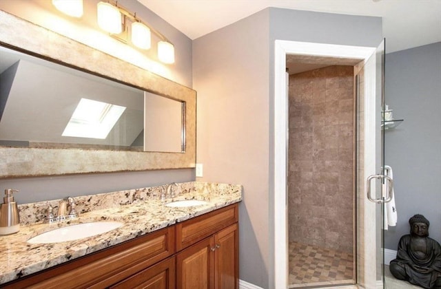 857 Adams St Unit 857, Boston, MA 02124 - bathroom with a skylight, double vanity, a shower stall, and baseboards