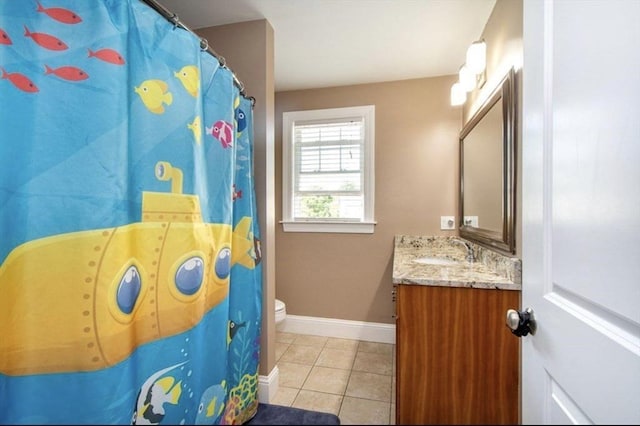857 Adams St Unit 857, Boston, MA 02124 - bathroom with vanity, toilet, tile patterned flooring, and baseboards