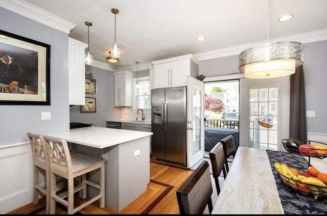 857 Adams St Unit 857, Boston, MA 02124 - kitchen featuring stainless steel refrigerator with ice dispenser, ornamental molding, a peninsula, white cabinets, and light wood-style flooring
