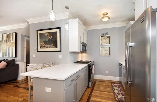 857 Adams St Unit 857, Boston, MA 02124 - kitchen featuring stainless steel appliances, a kitchen breakfast bar, dark wood finished floors, a peninsula, and gray cabinets