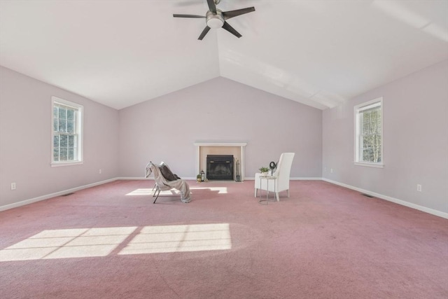 unfurnished room with lofted ceiling, light colored carpet, and a healthy amount of sunlight