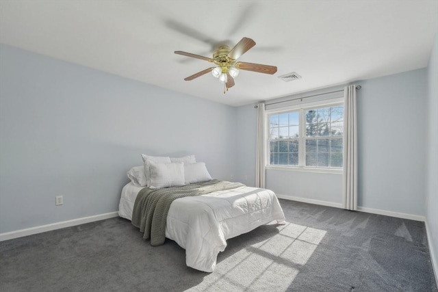 bedroom with ceiling fan and dark carpet