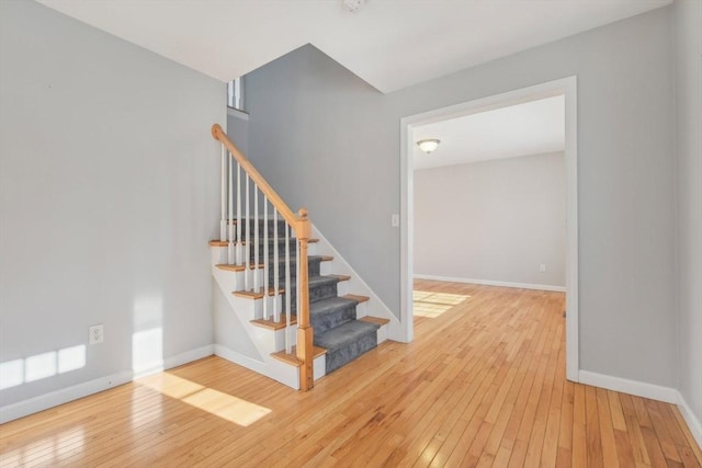 stairs featuring wood-type flooring