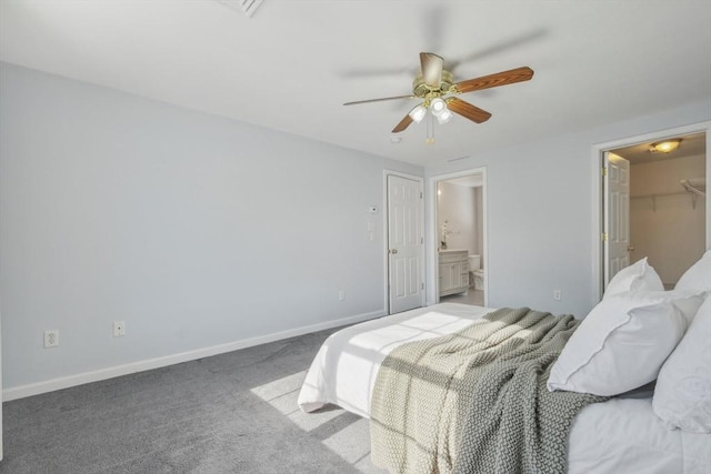 carpeted bedroom featuring a spacious closet, a closet, and ceiling fan