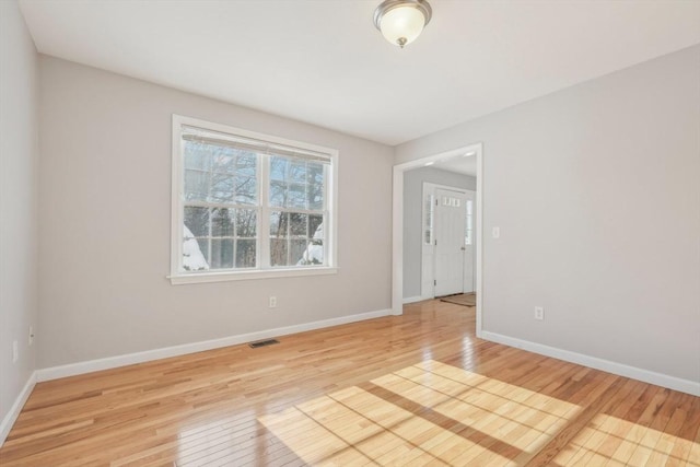 unfurnished room with light wood-type flooring