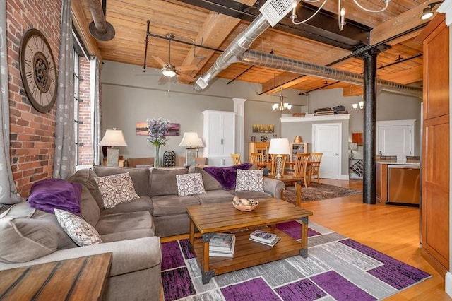 living room featuring beamed ceiling, wood ceiling, and brick wall