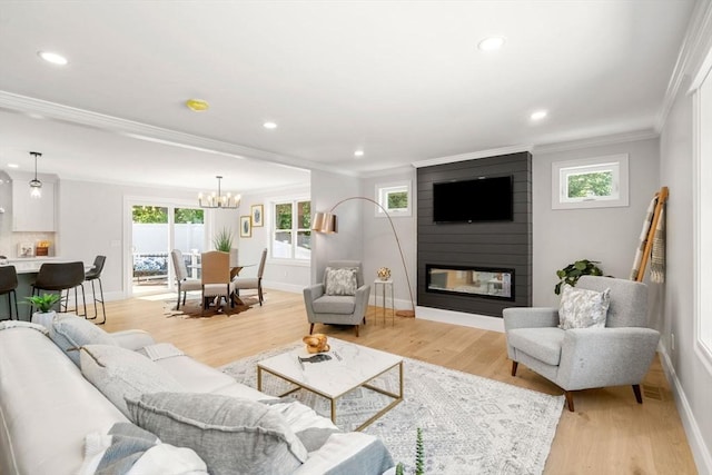2 Suncrest Ave, Wilmington, MA 01887 - living area featuring ornamental molding, a chandelier, a fireplace, healthy amount of natural light, and recessed lighting