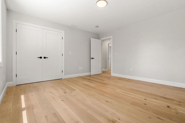 2 Suncrest Ave, Wilmington, MA 01887 - unfurnished bedroom featuring light wood-type flooring and a closet
