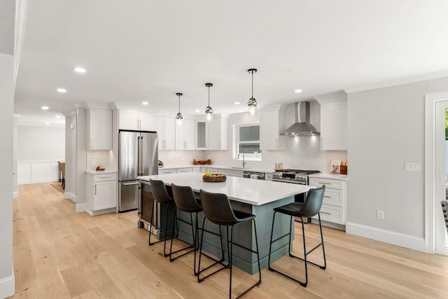 2 Suncrest Ave, Wilmington, MA 01887 - kitchen with stainless steel appliances, wall chimney range hood, recessed lighting, a center island, and light countertops