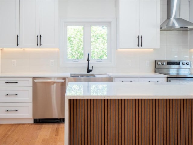 28 Berkshire Ave, Sharon, MA 02067 - kitchen with wall chimney exhaust hood, stainless steel appliances, white cabinets, decorative backsplash, and light stone countertops