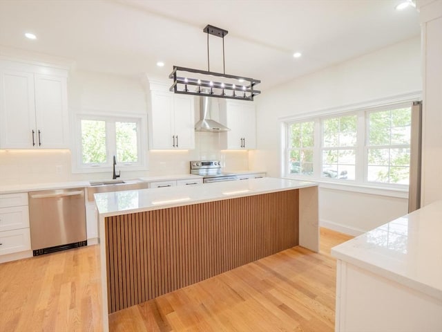 28 Berkshire Ave, Sharon, MA 02067 - kitchen with appliances with stainless steel finishes, wall chimney range hood, backsplash, healthy amount of natural light, and recessed lighting