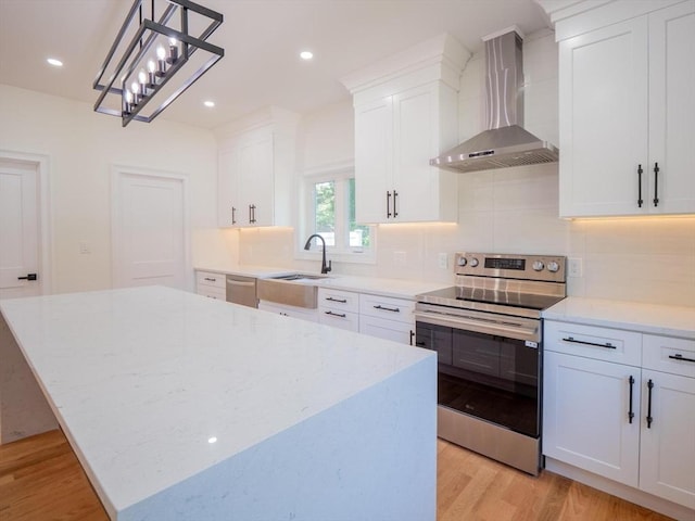 28 Berkshire Ave, Sharon, MA 02067 - kitchen with stainless steel appliances, wall chimney exhaust hood, light wood-style floors, tasteful backsplash, and recessed lighting