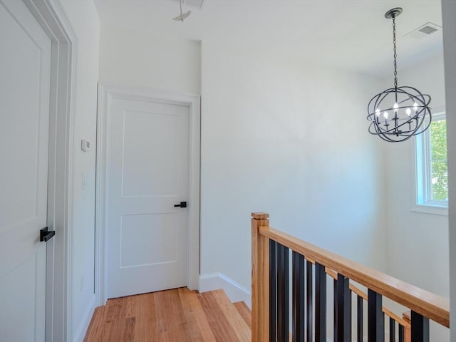 28 Berkshire Ave, Sharon, MA 02067 - hall featuring light wood-type flooring, a chandelier, and an upstairs landing