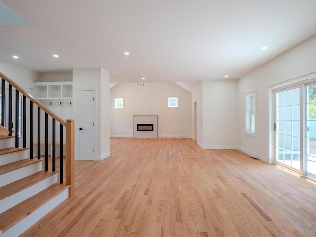 28 Berkshire Ave, Sharon, MA 02067 - unfurnished living room with plenty of natural light, light wood-type flooring, recessed lighting, and stairs