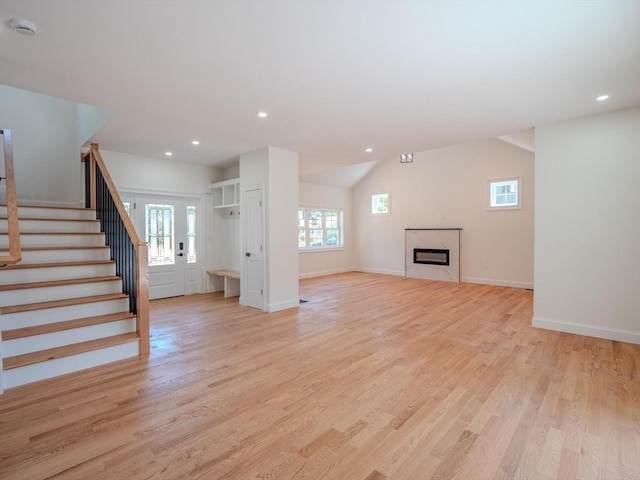 28 Berkshire Ave, Sharon, MA 02067 - unfurnished living room with stairs, plenty of natural light, light wood-type flooring, recessed lighting, and lofted ceiling